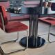 Round black smoked glass dining table + 2 terracotta chairs