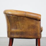 Subtle sheepskin club chair finished with decorative studs