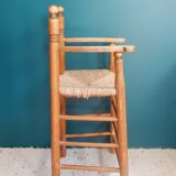 Children's high chair made of wood and straw