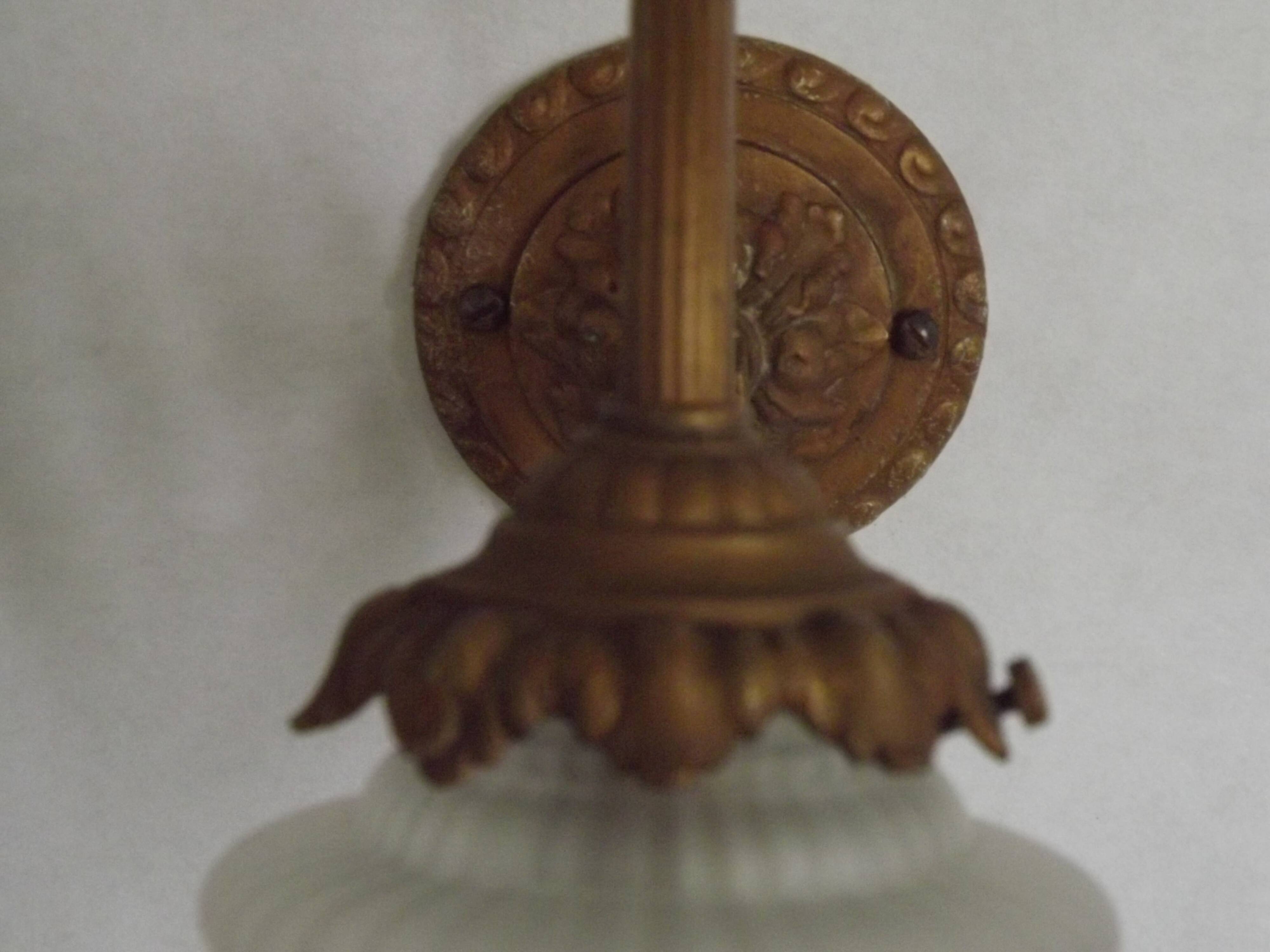 French Art Nouveau wall sconce in bronze with a white and pink glass shade.