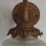 French Art Nouveau wall sconce in bronze with a white and pink glass shade.