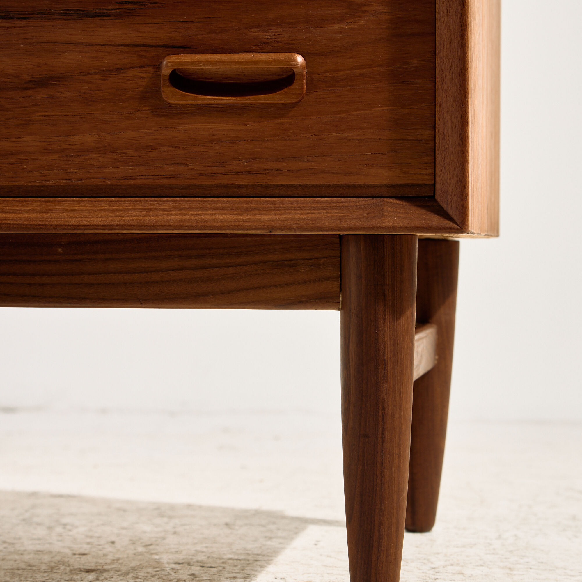 Restored teak chest of drawers with seven drawers.
