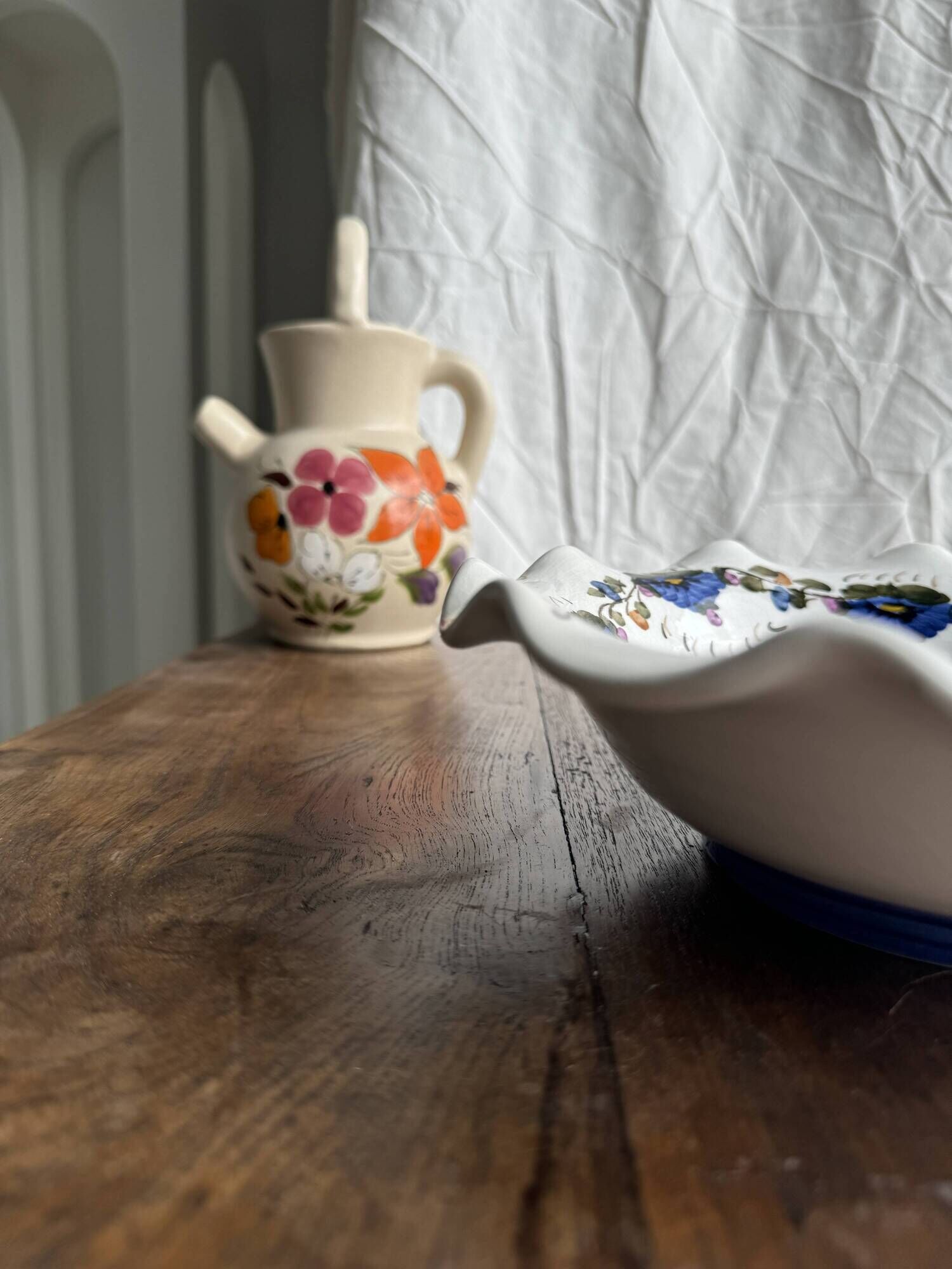 Small hand-painted earthenware salad bowl with garland of blue flowers, mark below