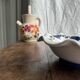 Small hand-painted earthenware salad bowl with garland of blue flowers, mark below