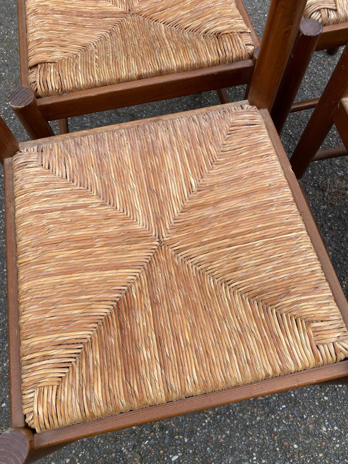 4 dining or kitchen chairs made of solid wood with rush seats.
