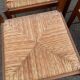 4 dining or kitchen chairs made of solid wood with rush seats.