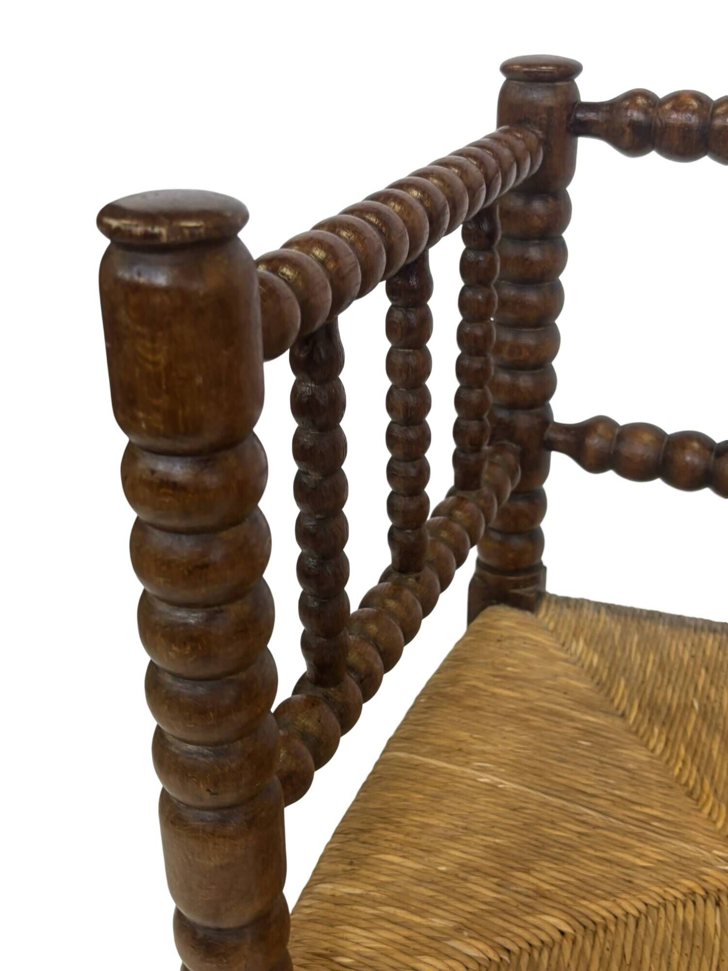 Vintage 'bobbin' bench with a rush seat, 1920s design with armrests.