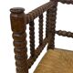 Vintage 'bobbin' bench with a rush seat, 1920s design with armrests.