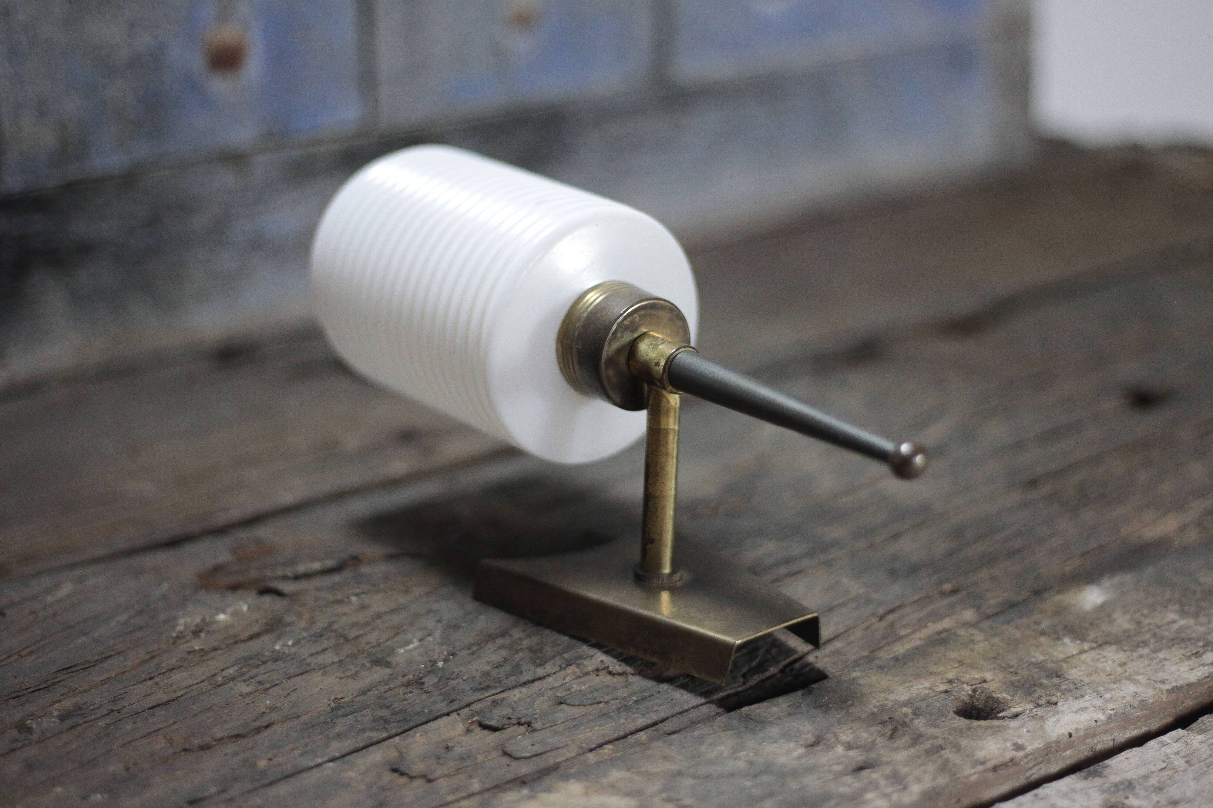 Brass wall light, black lacquered metal and white opal glass, 50s.