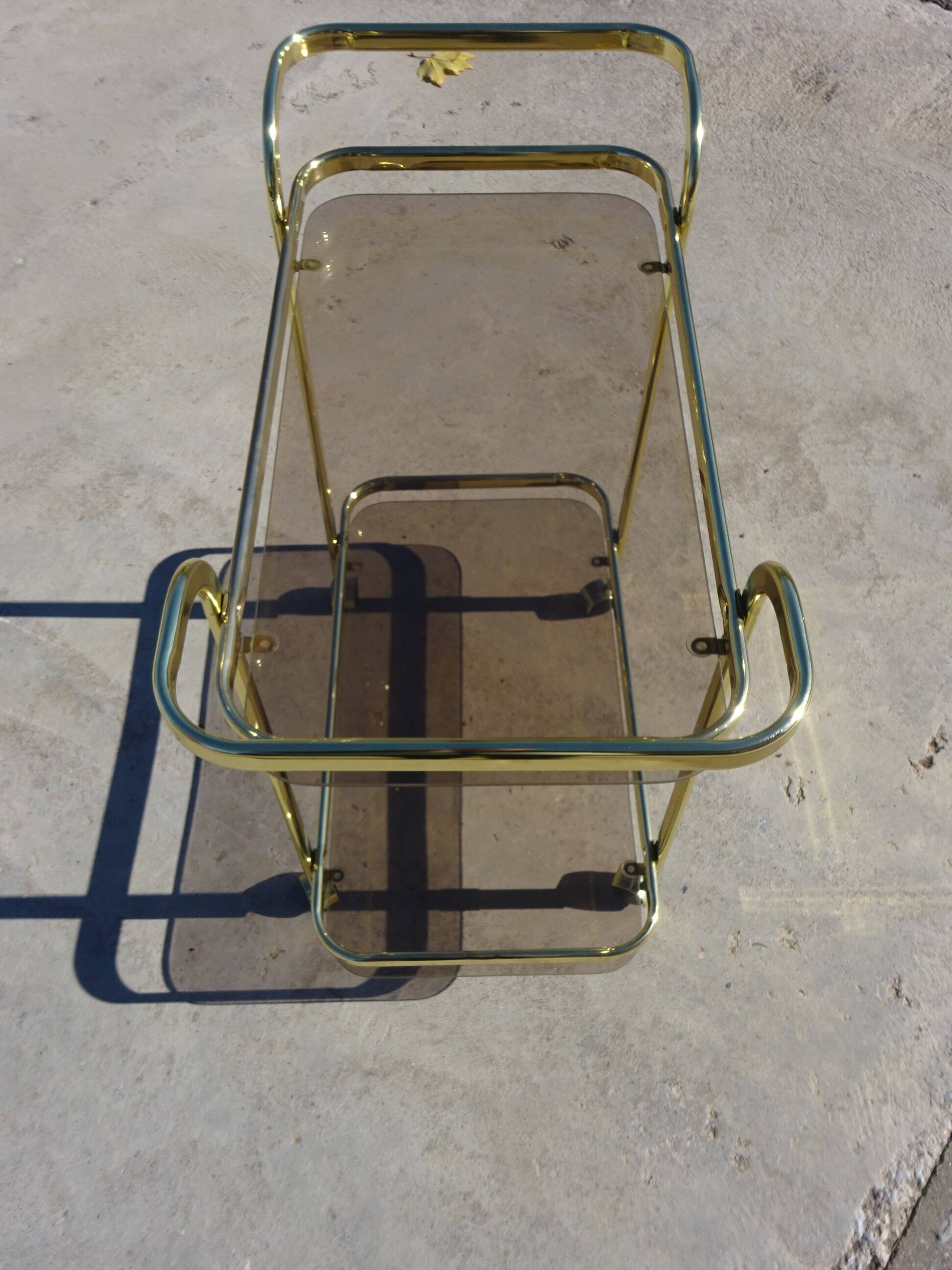 Golden metal and smoked glass dessert table