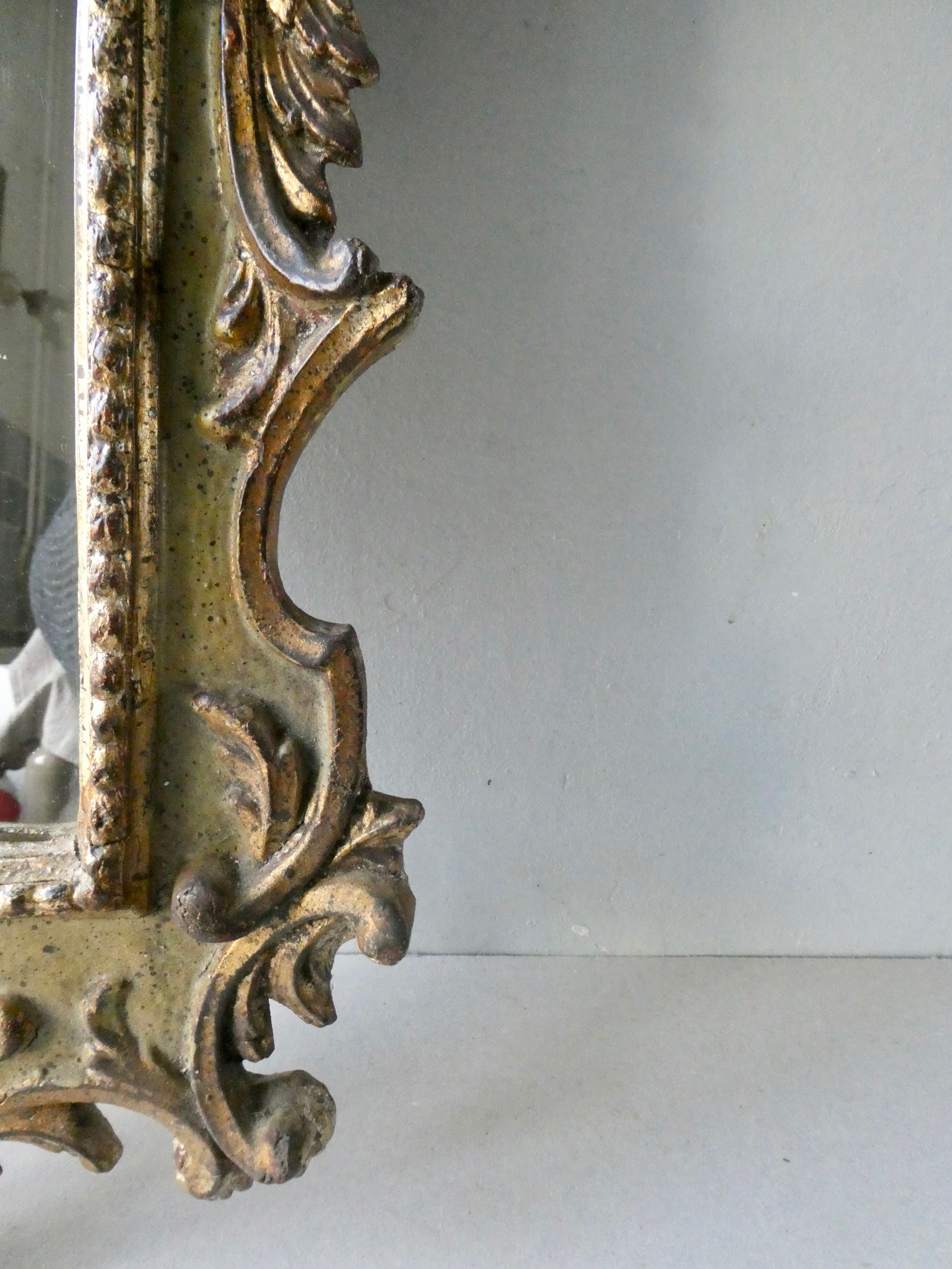 Mirror with cherub head in gilded wood, Venetian baroque style