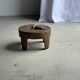 Small low circular four-legged stool in organic old teak with cut-out design H2