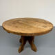 Round table in solid wood, thick top, vintage brutalist style from the 1960s.