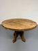 Round table in solid wood, thick top, vintage brutalist style from the 1960s.