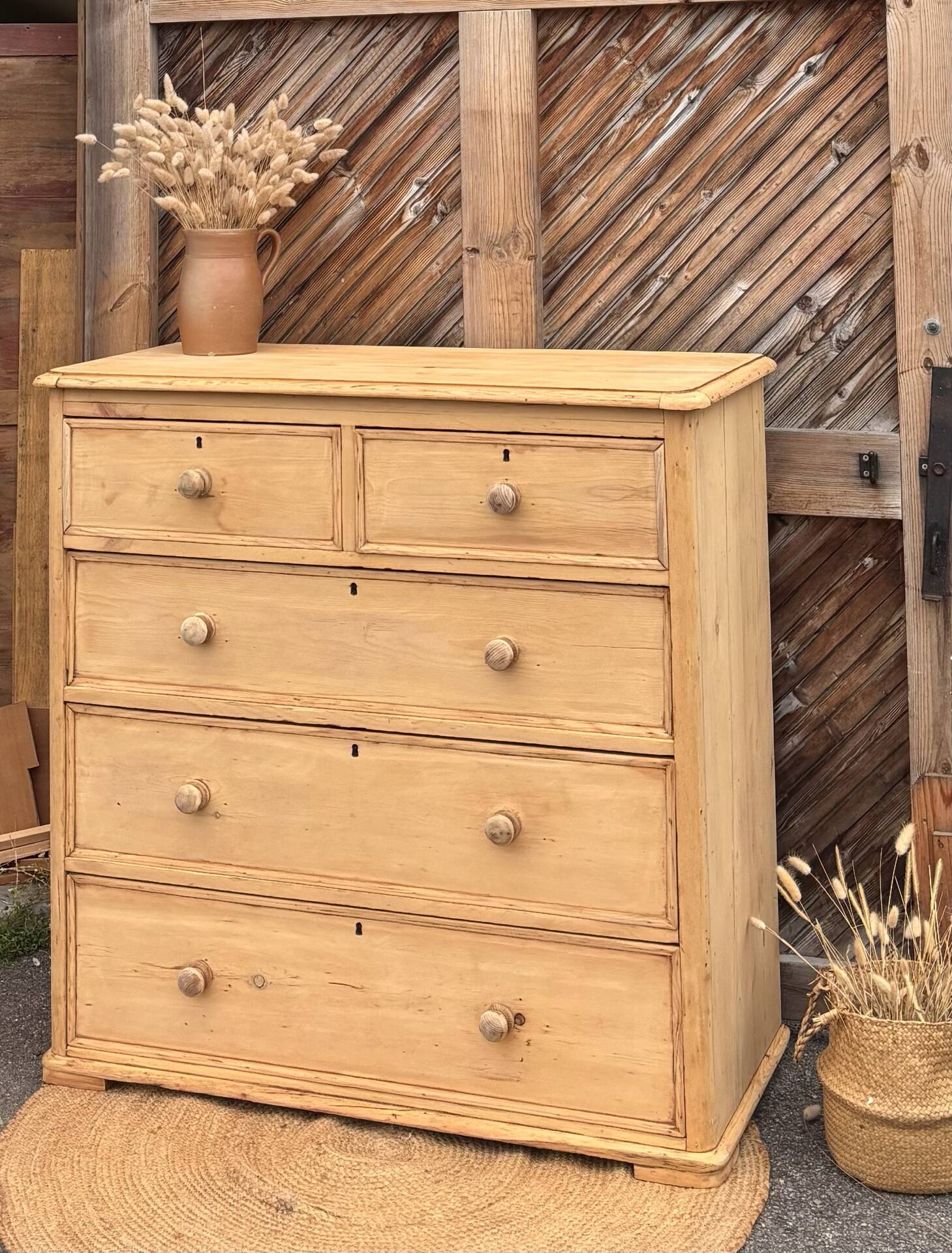 Large antique English chest of drawers in raw solid wood.