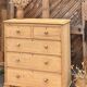 Large antique English chest of drawers in raw solid wood.