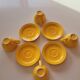4 yellow cups and saucers