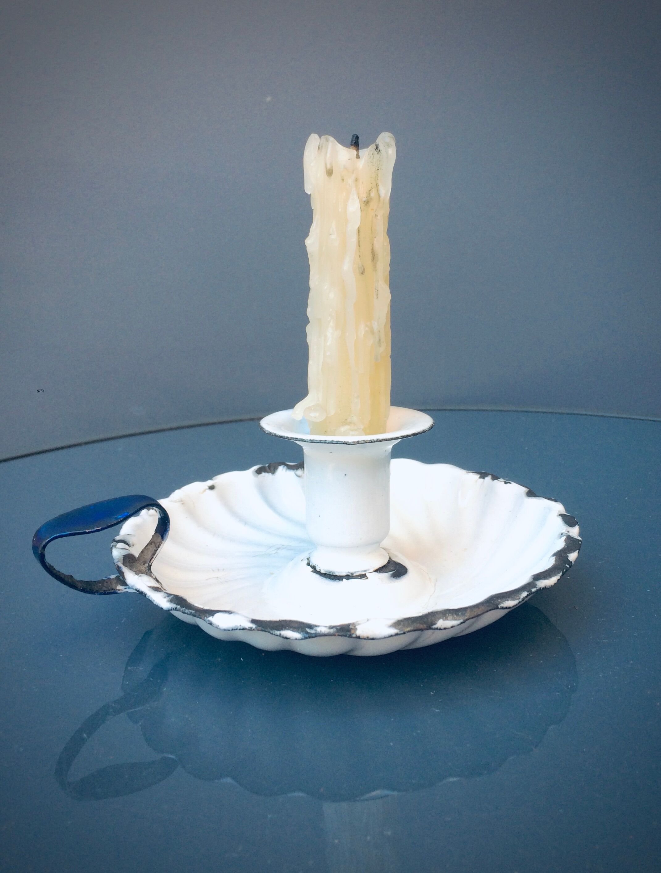 Old white enamelled candlestick