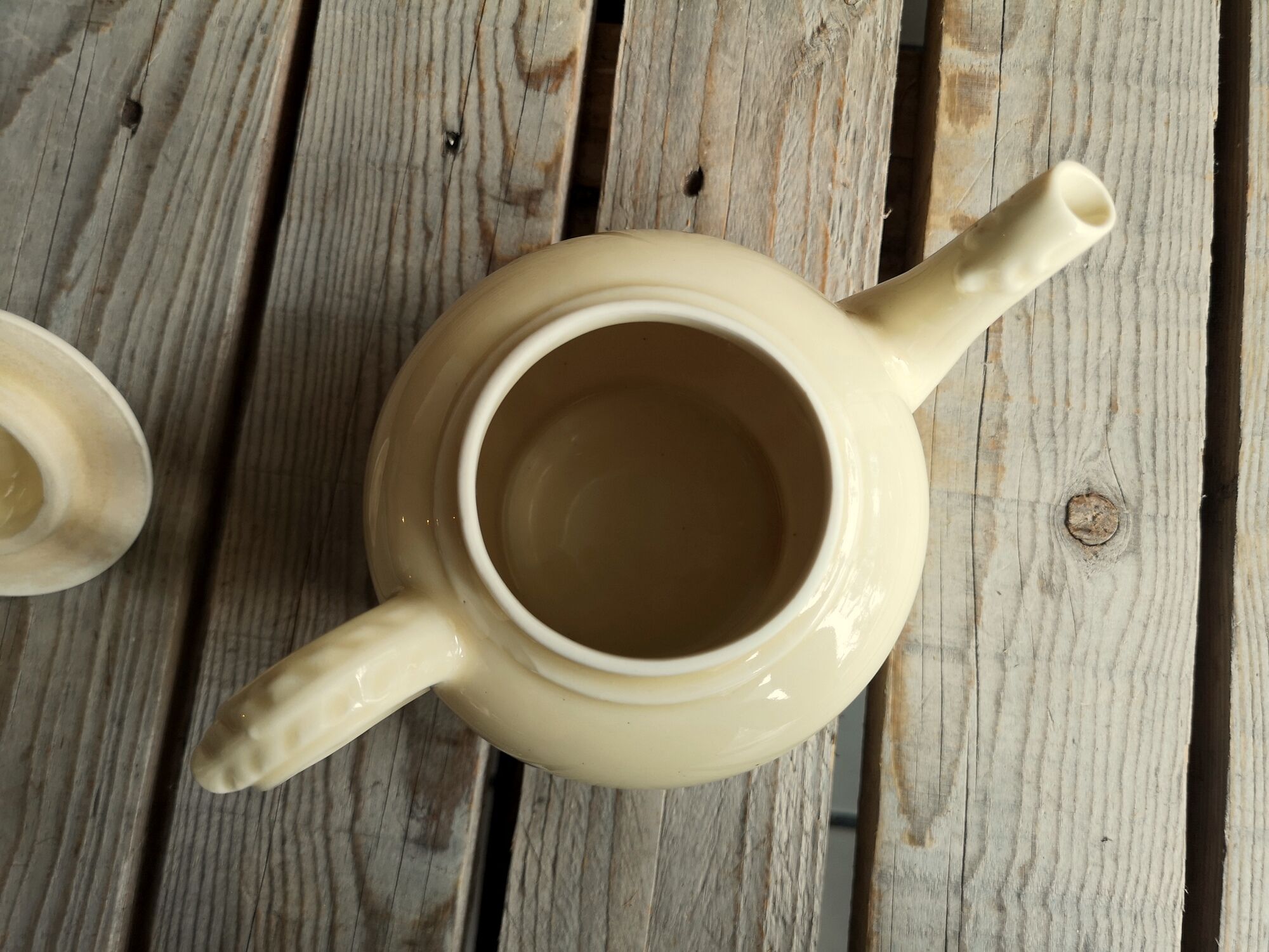 Little ancient teapot in ceramics color cream
