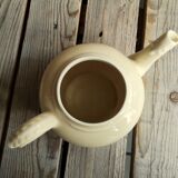 Little ancient teapot in ceramics color cream