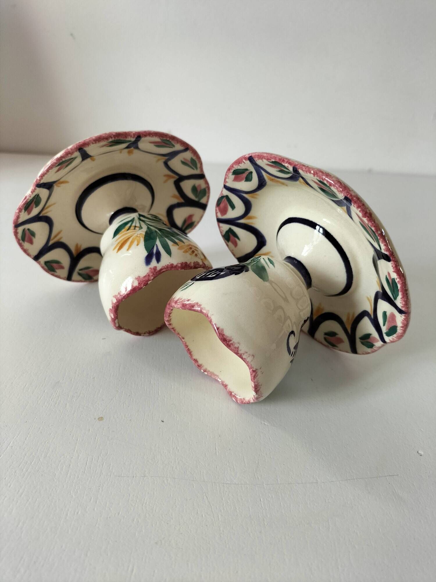 Pair of HB Quimper egg cups with integrated pedestal base, floral decoration