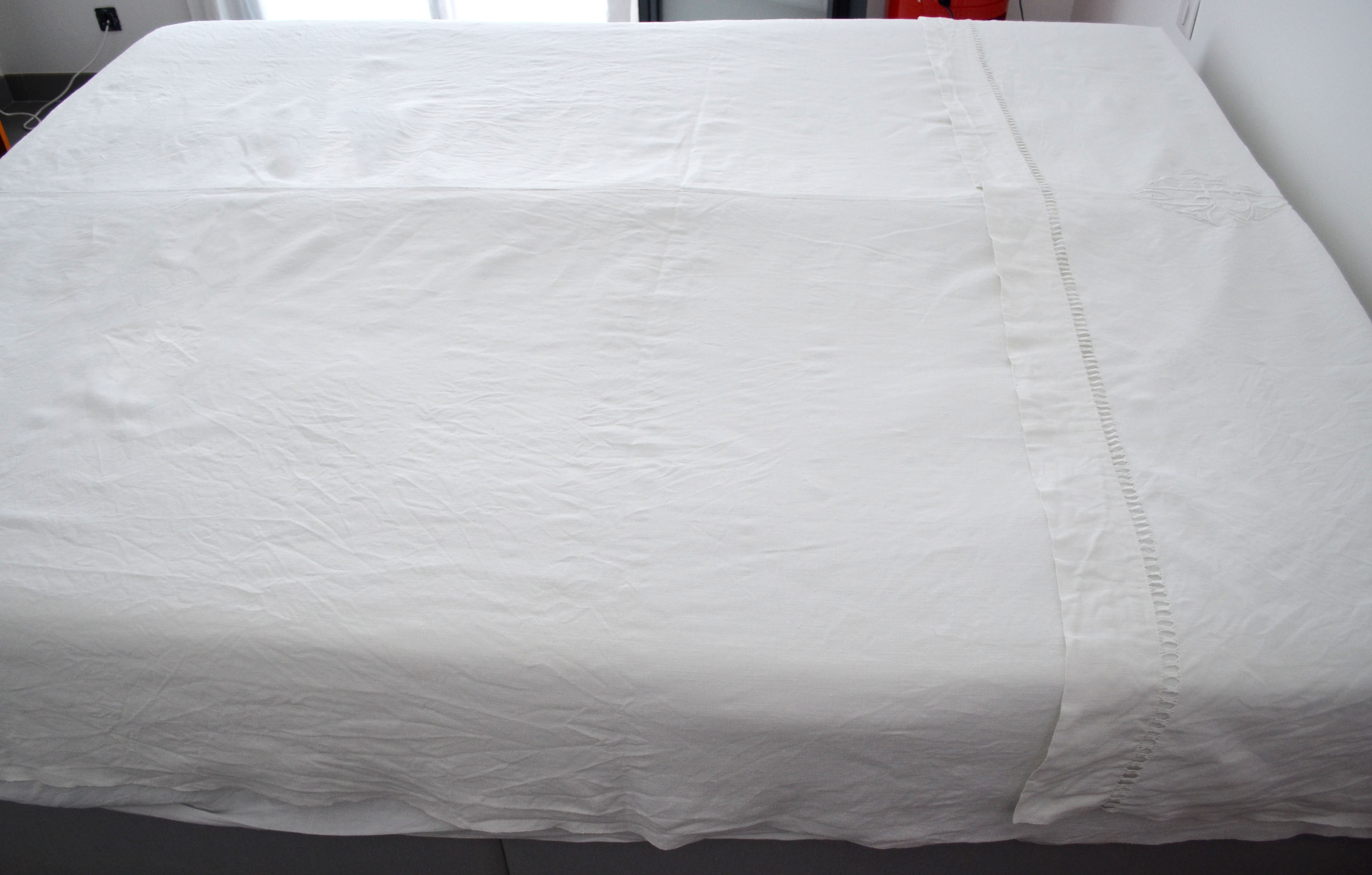 White sheet in monogrammed linen