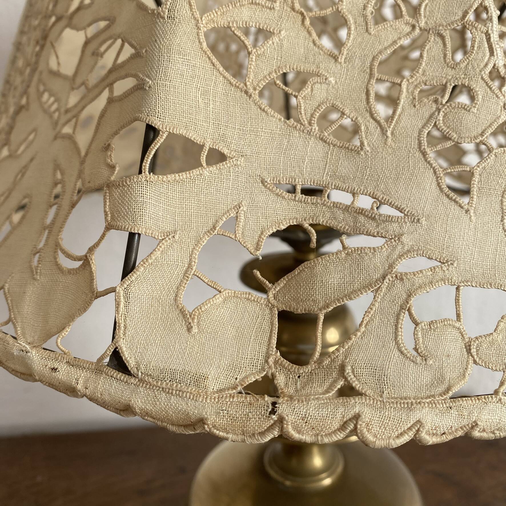Antique brass lamp with embroidered openwork shade.