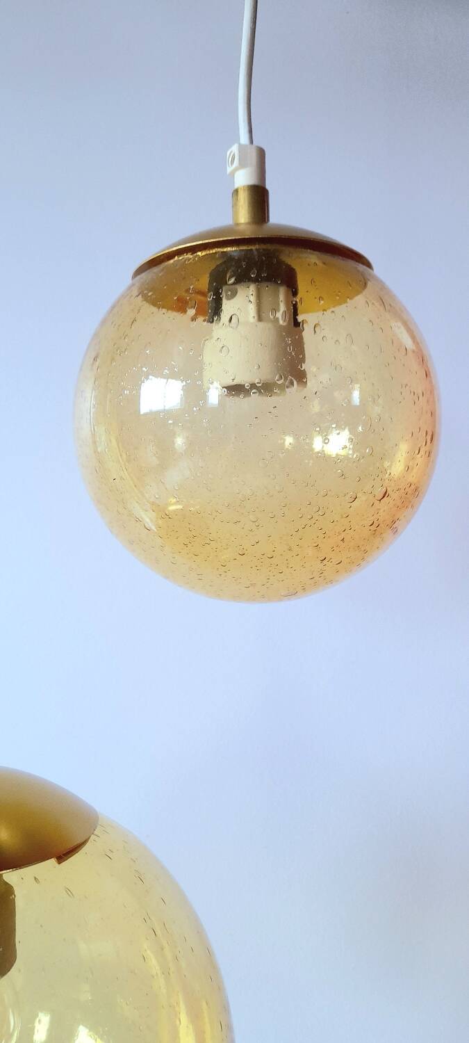 Set of 2 bubbled amber glass globe pendants