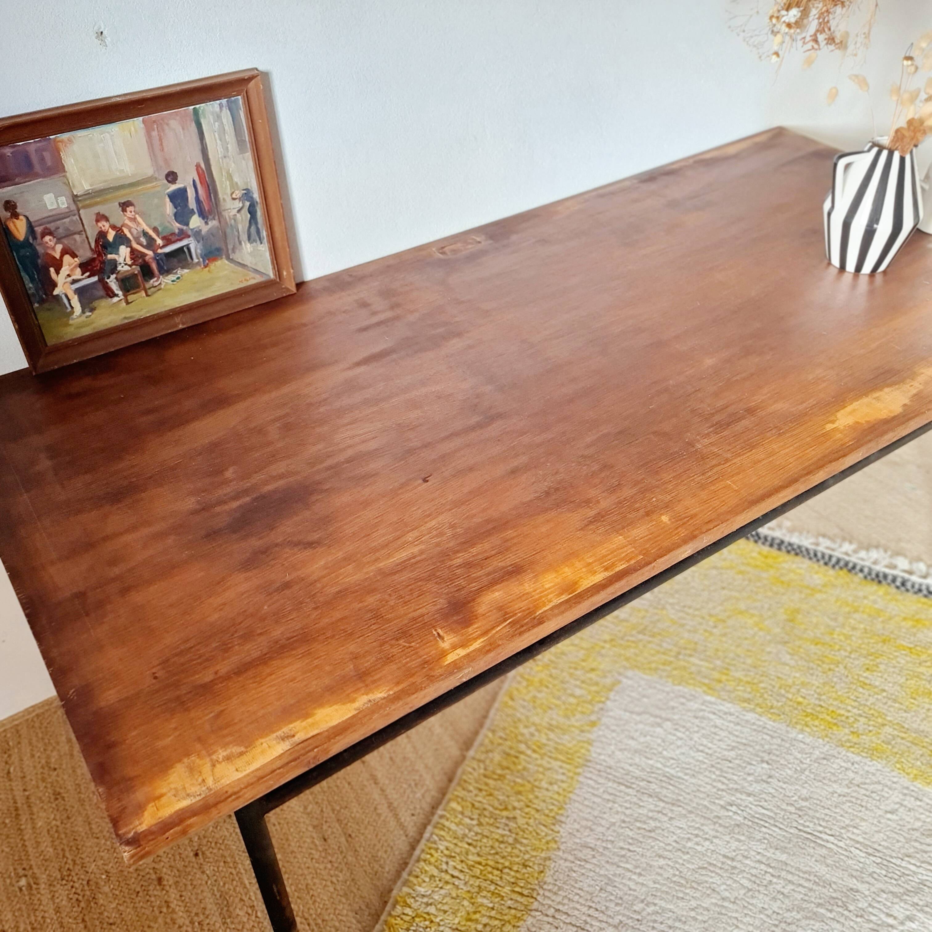 Metal tubular base table with a wooden top.