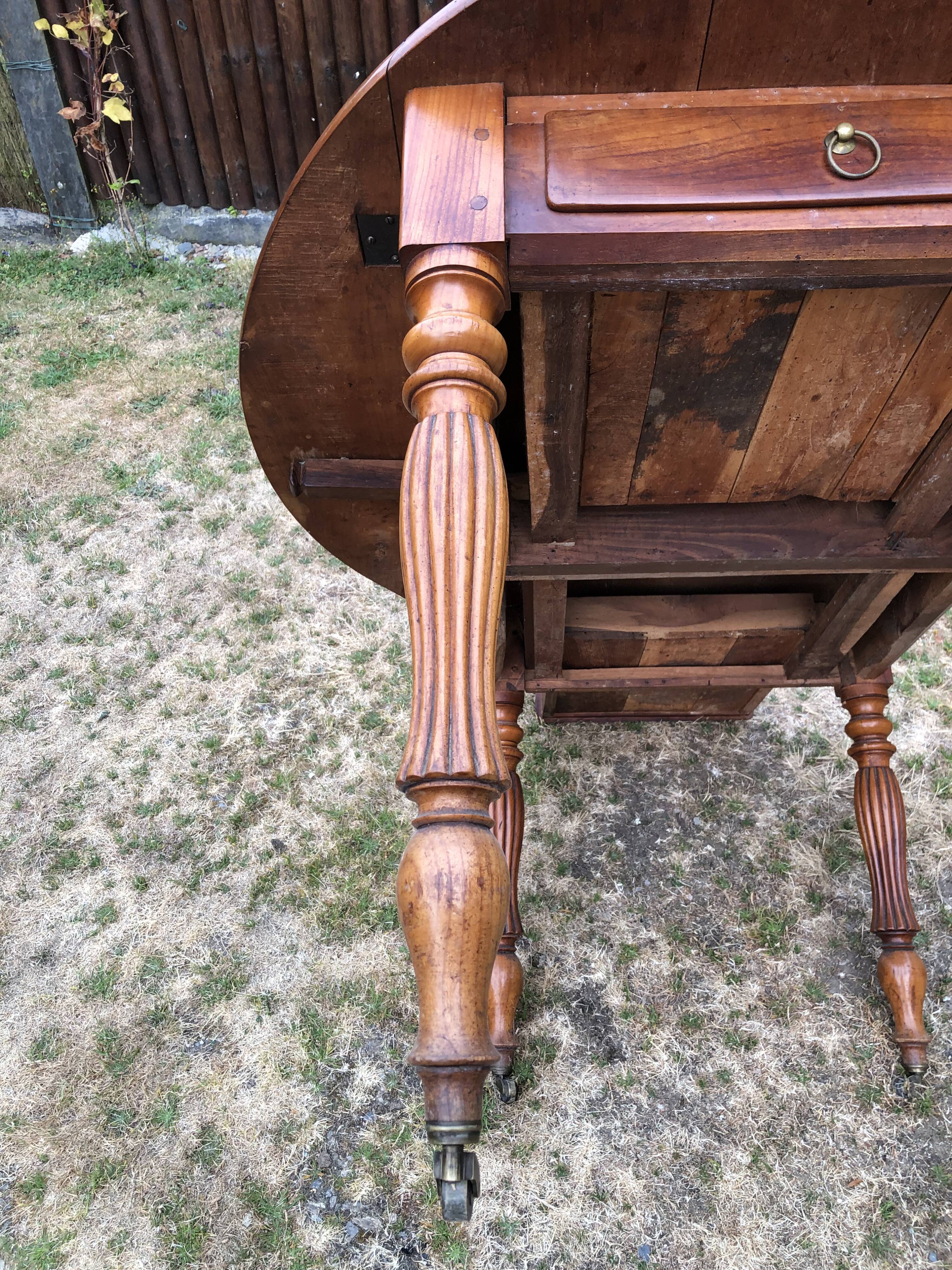 Louis Philippe oval drop-leaf table in solid cherry wood with 2 drawers.
