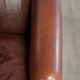 Characterful sheepskin club armchair in a dark cognac colour in English style