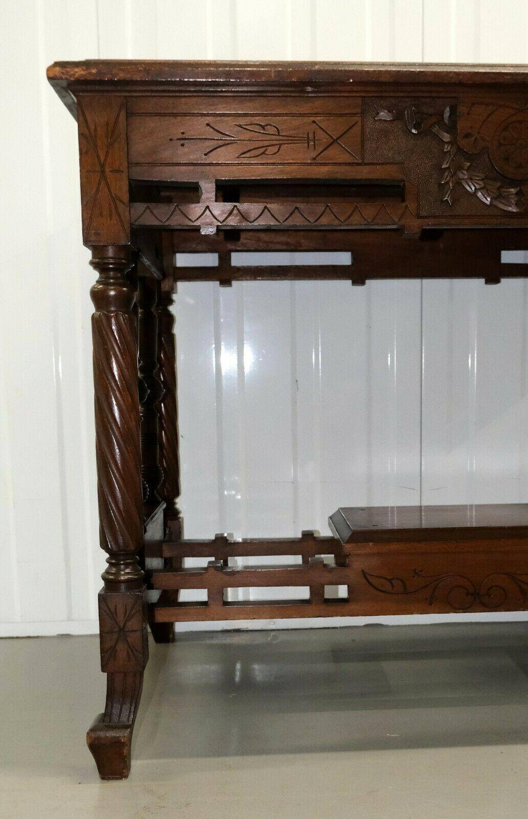 19th-century carved walnut desk with a leather top.