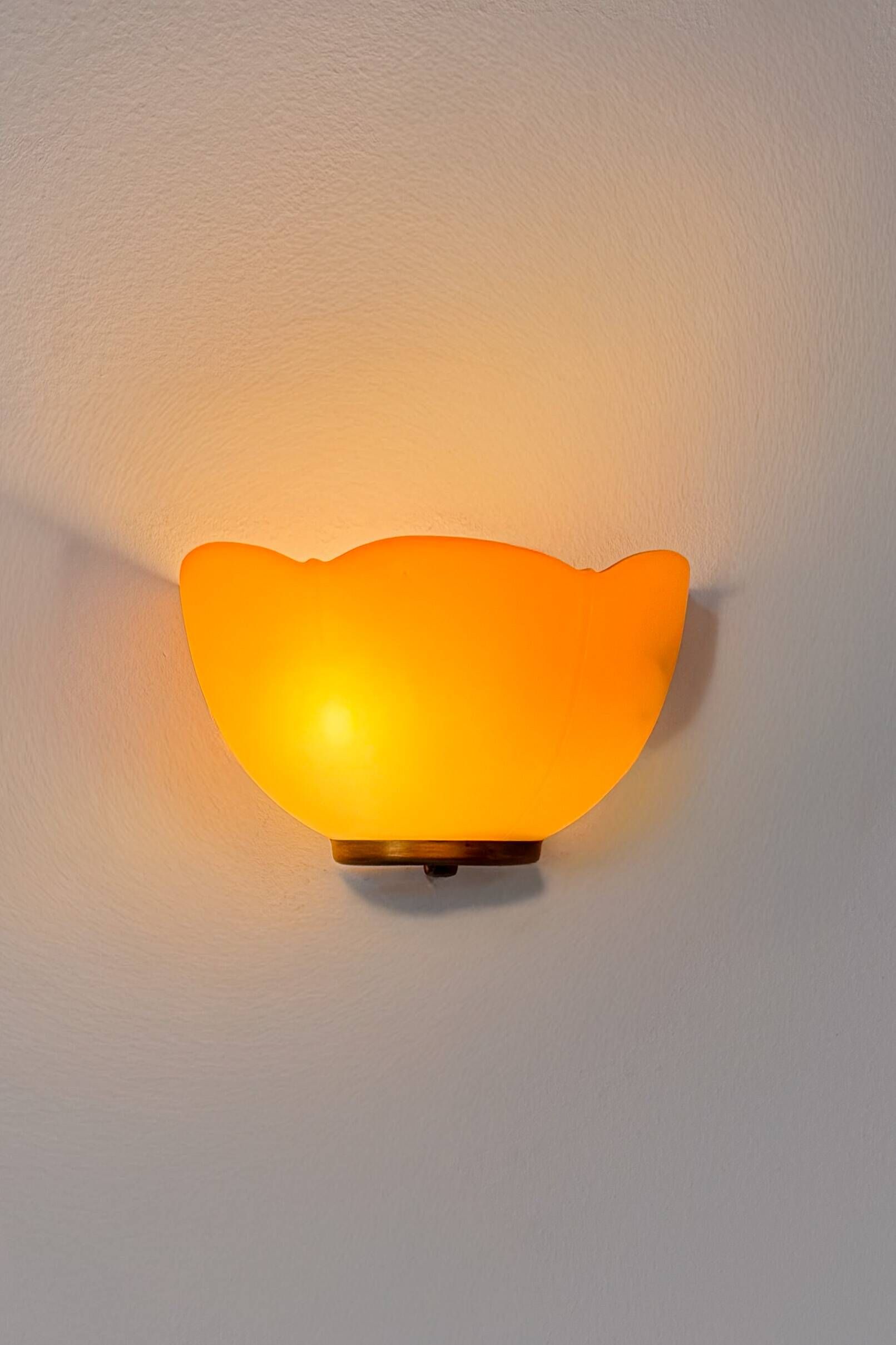 Vintage brass and orange glass wall sconces, France 1970.