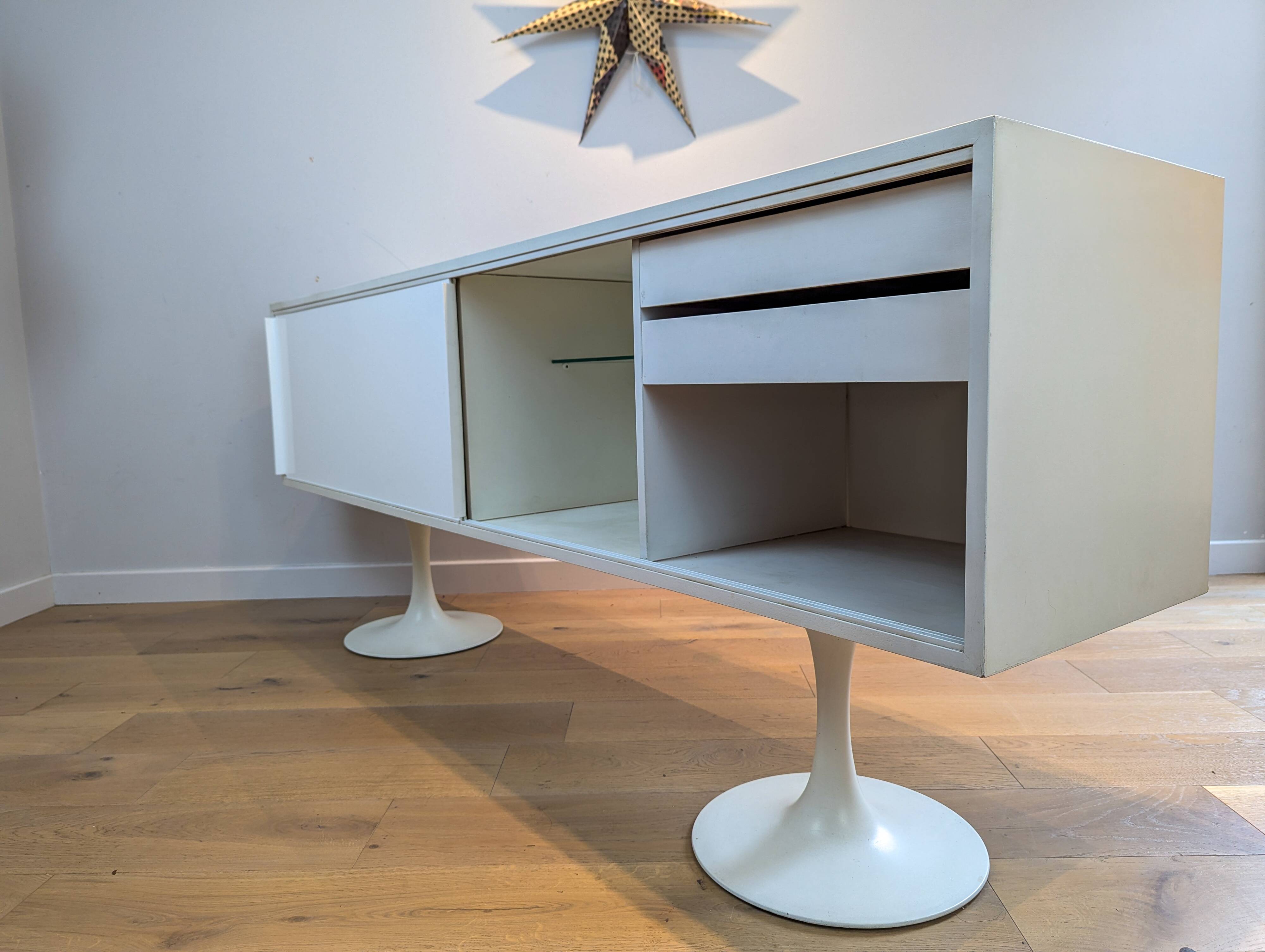 A vintage mid century space age sideboard with white sliding doors