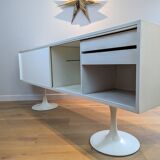 A vintage mid century space age sideboard with white sliding doors