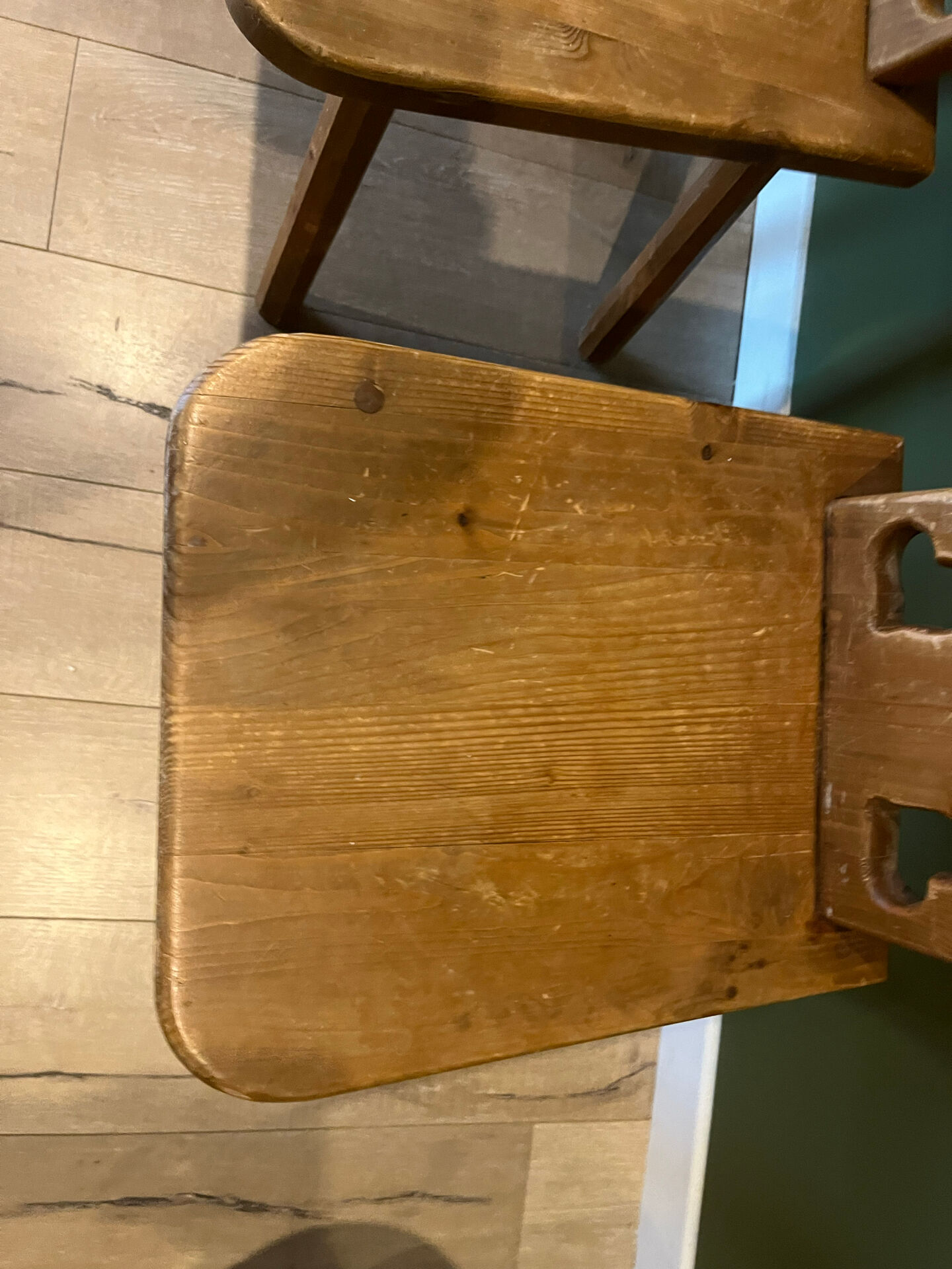 Pair of vintage wooden chairs in alpine chalet style.