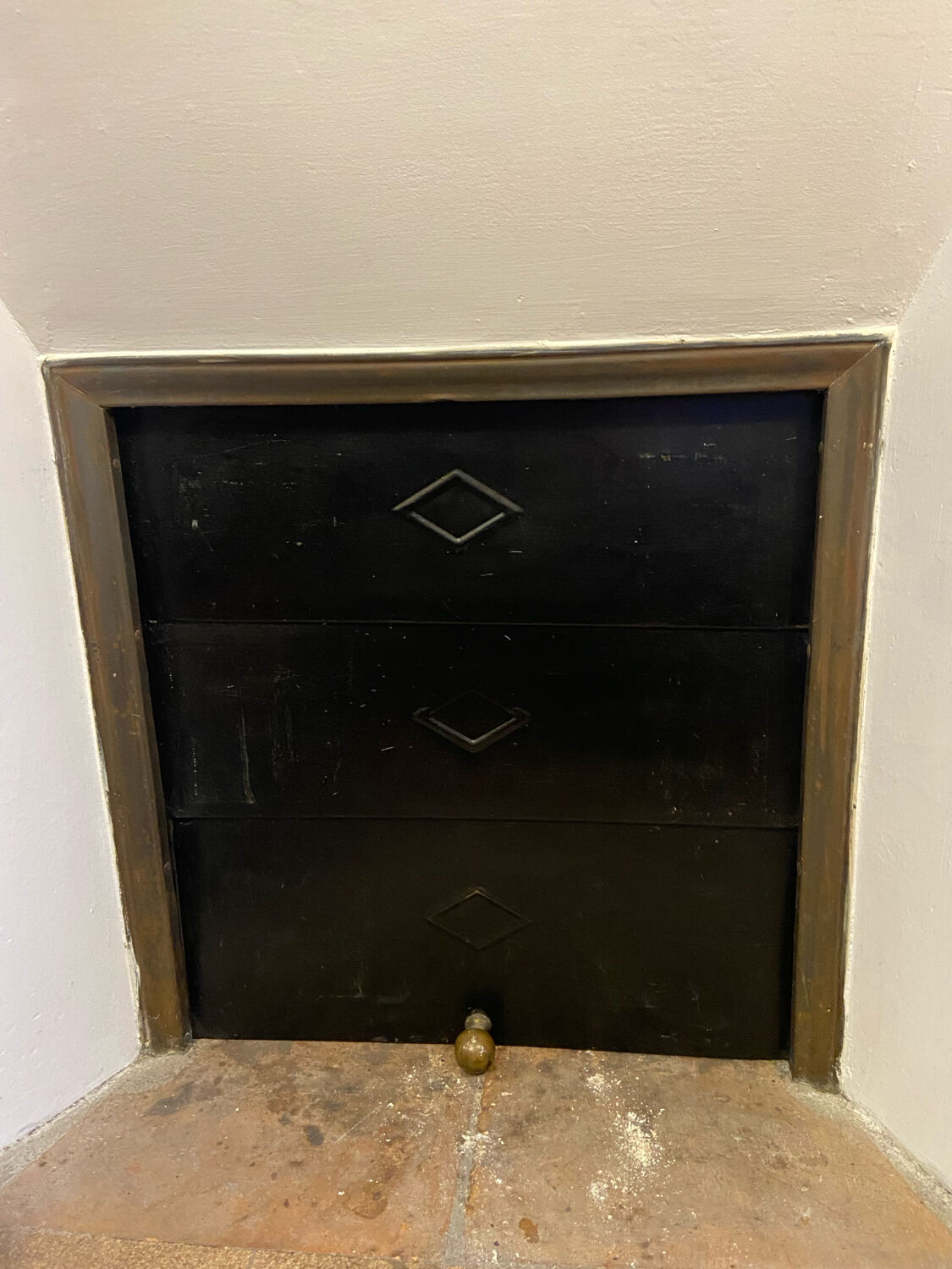 Marble fireplace surround with closed hearth frame.