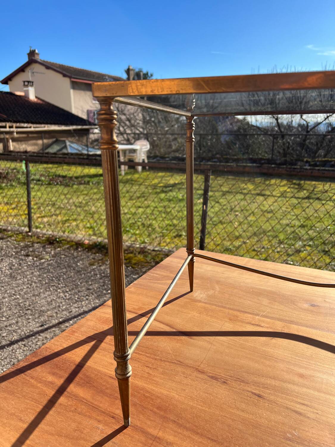 Brass side table with smoked glass.