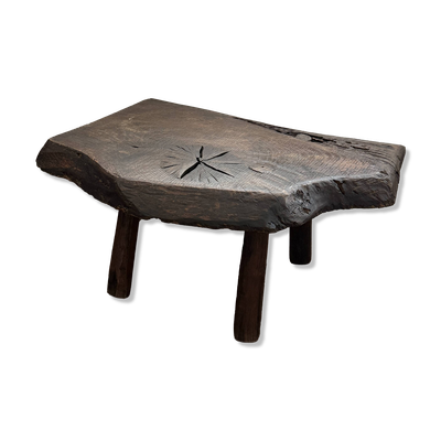 Table basse en bois massif avec une forme organique.