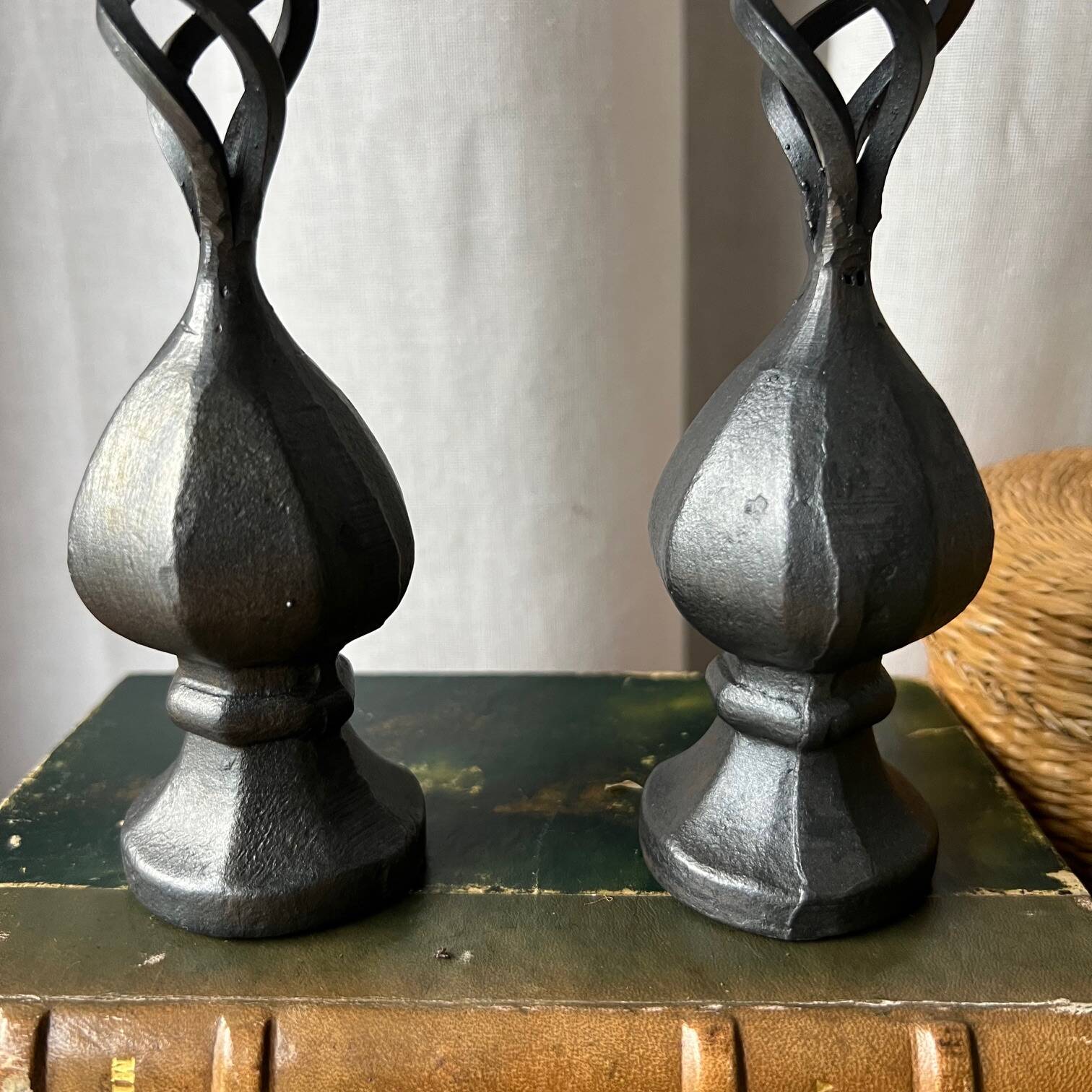Pair of wrought iron candlesticks, black patina