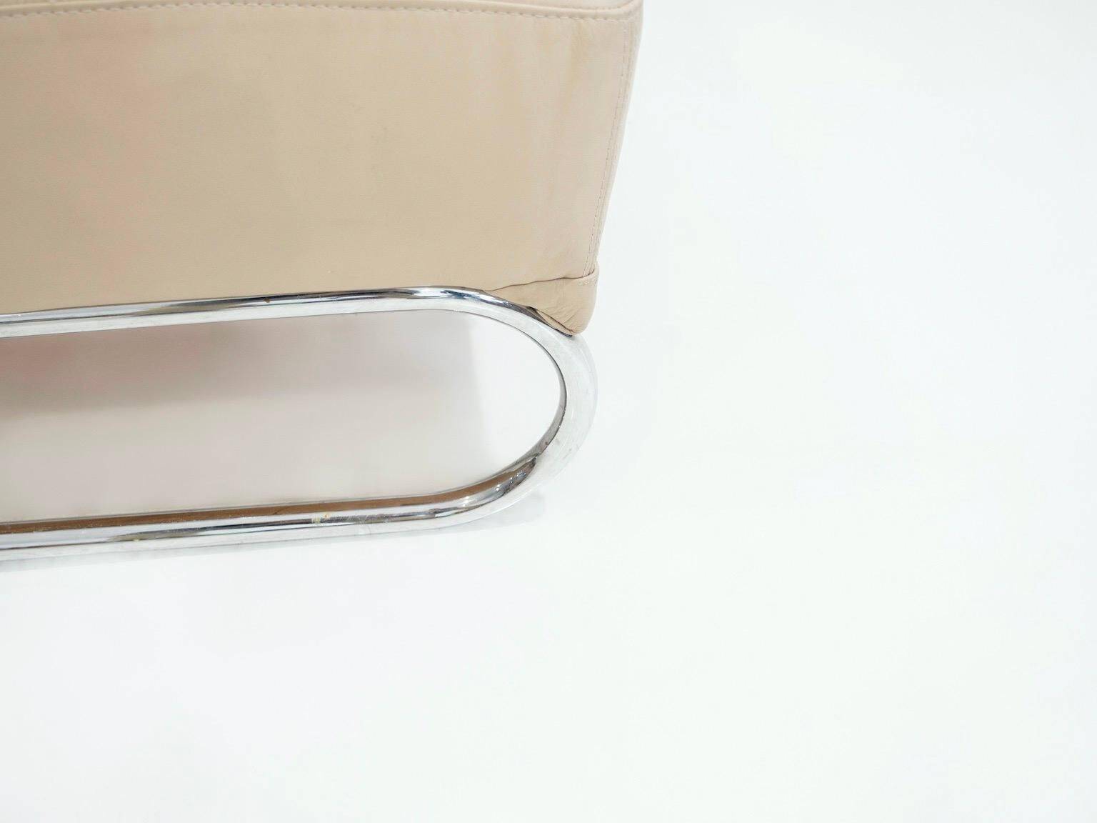 Pair of beige leather and tubular steel armchairs.