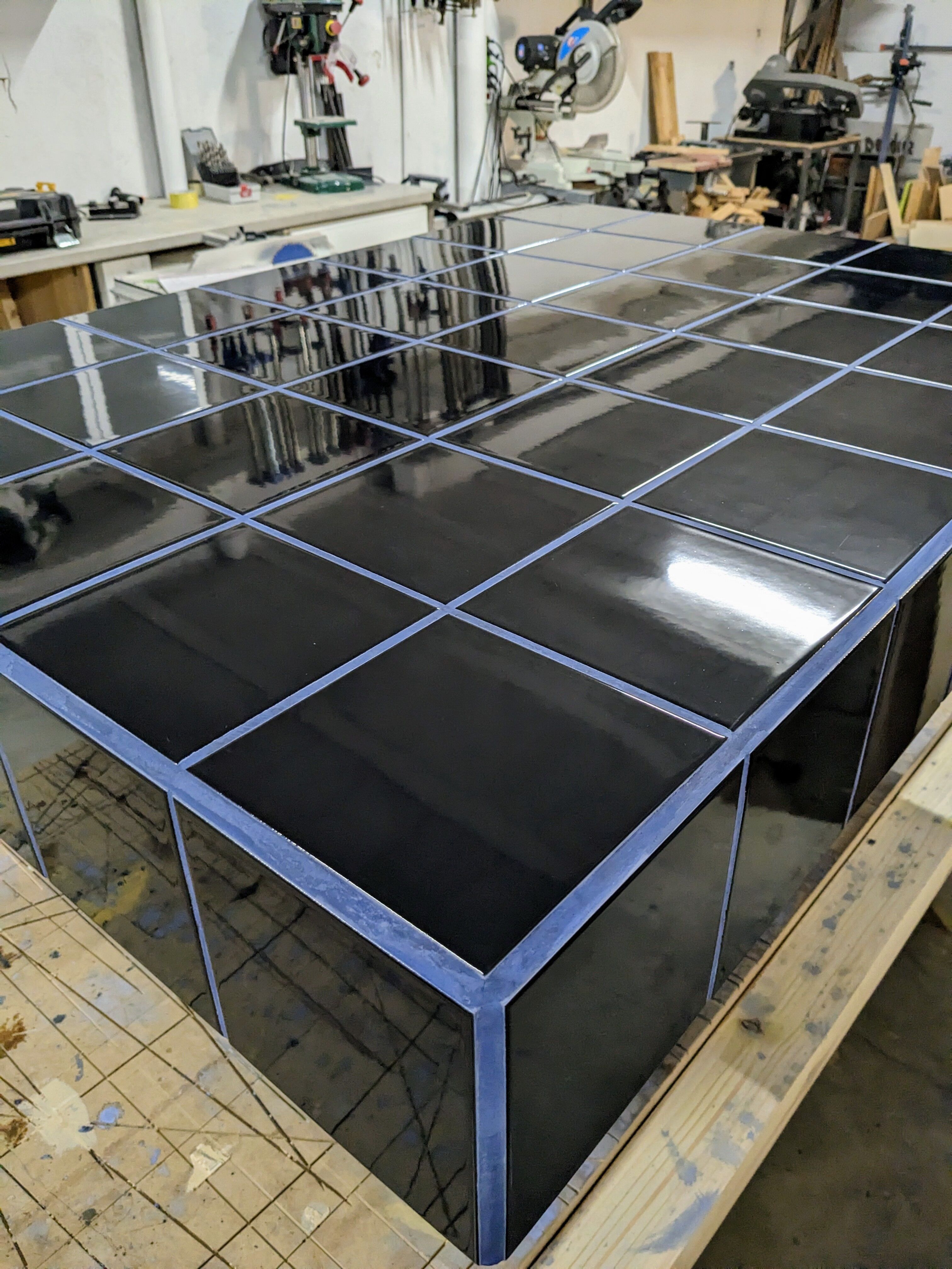 Black tiled coffee table and midnight blue grout
