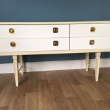 White retro wooden commode in Mid-Century style, tapered legs and gold handles (1960s)