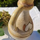 Handcrafted jug or jar with a handle, terracotta pottery vase, fat lava effect, stylized flowers