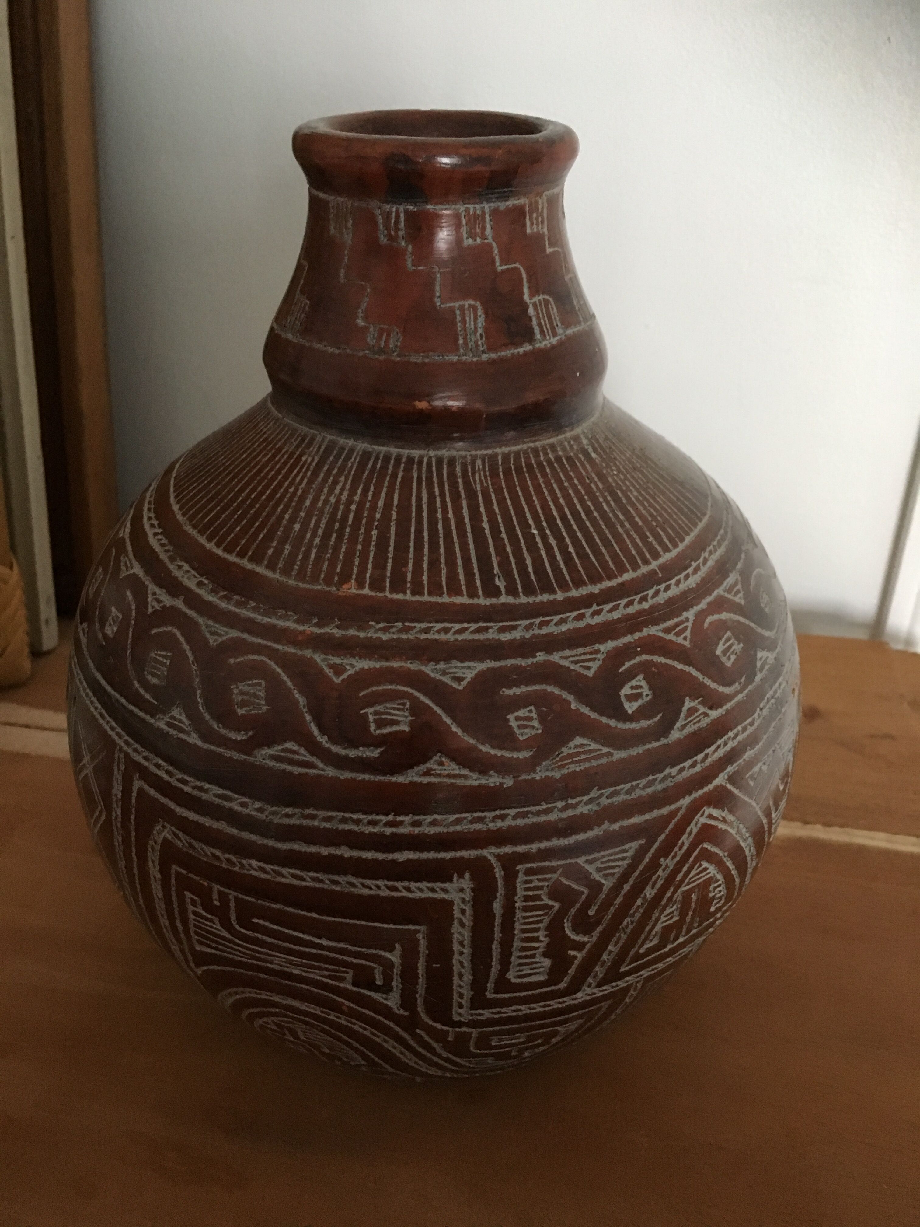Vase in earth baked ethnic graphic patterns