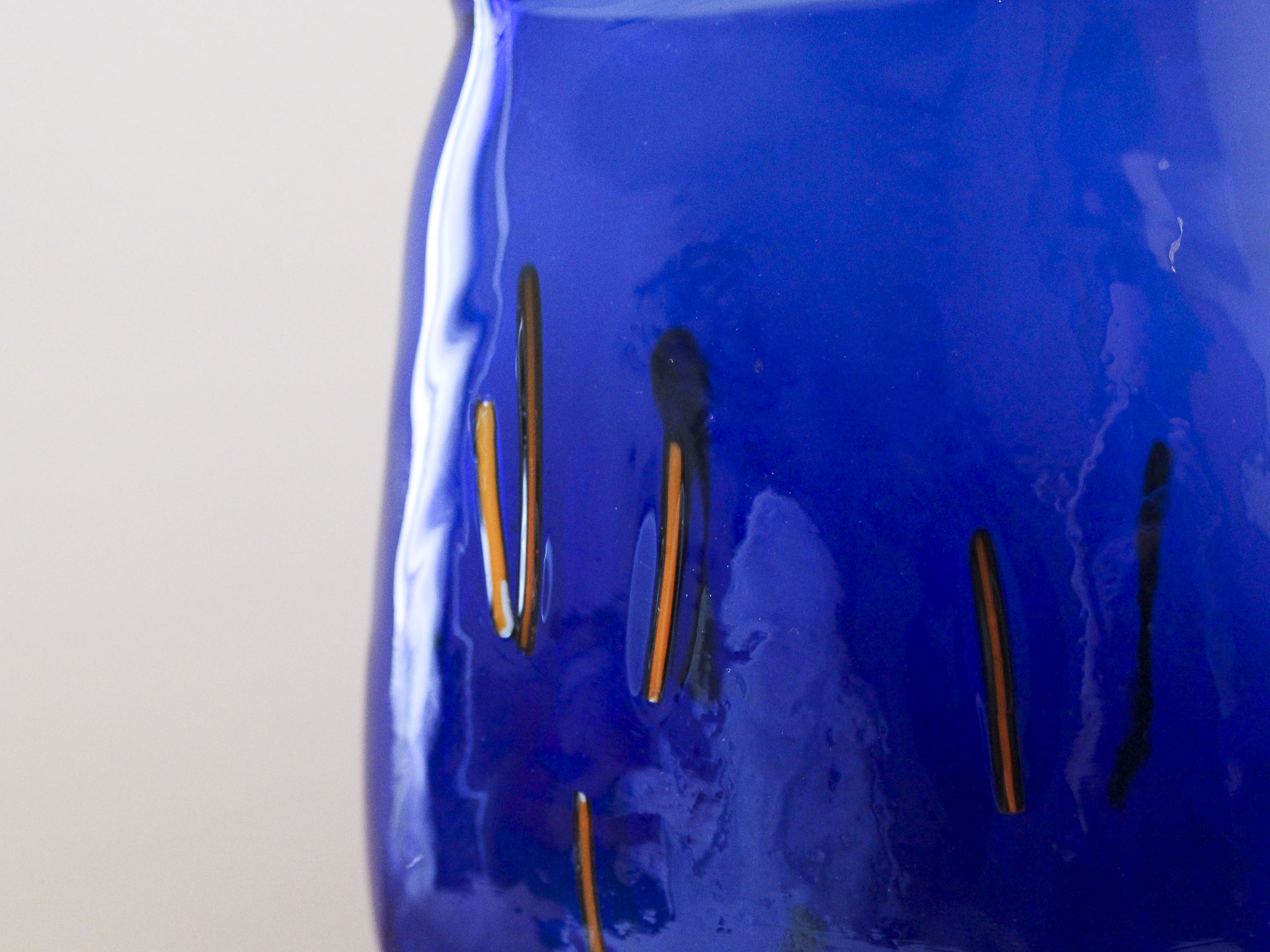 Blue blown glass vase and orange inclusion
