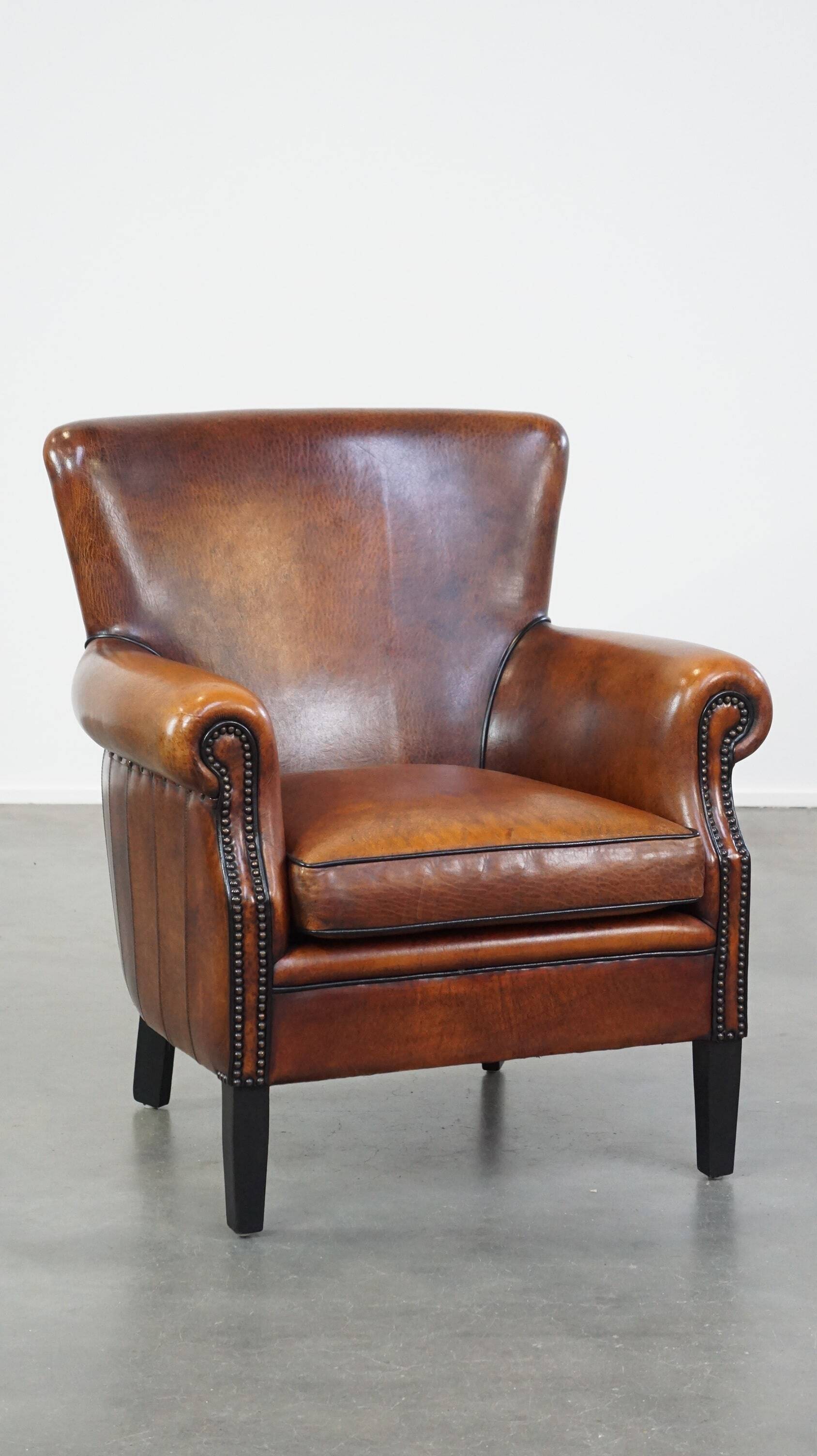 Sheepskin armchair/lounge chair finished with decorative nailheads
