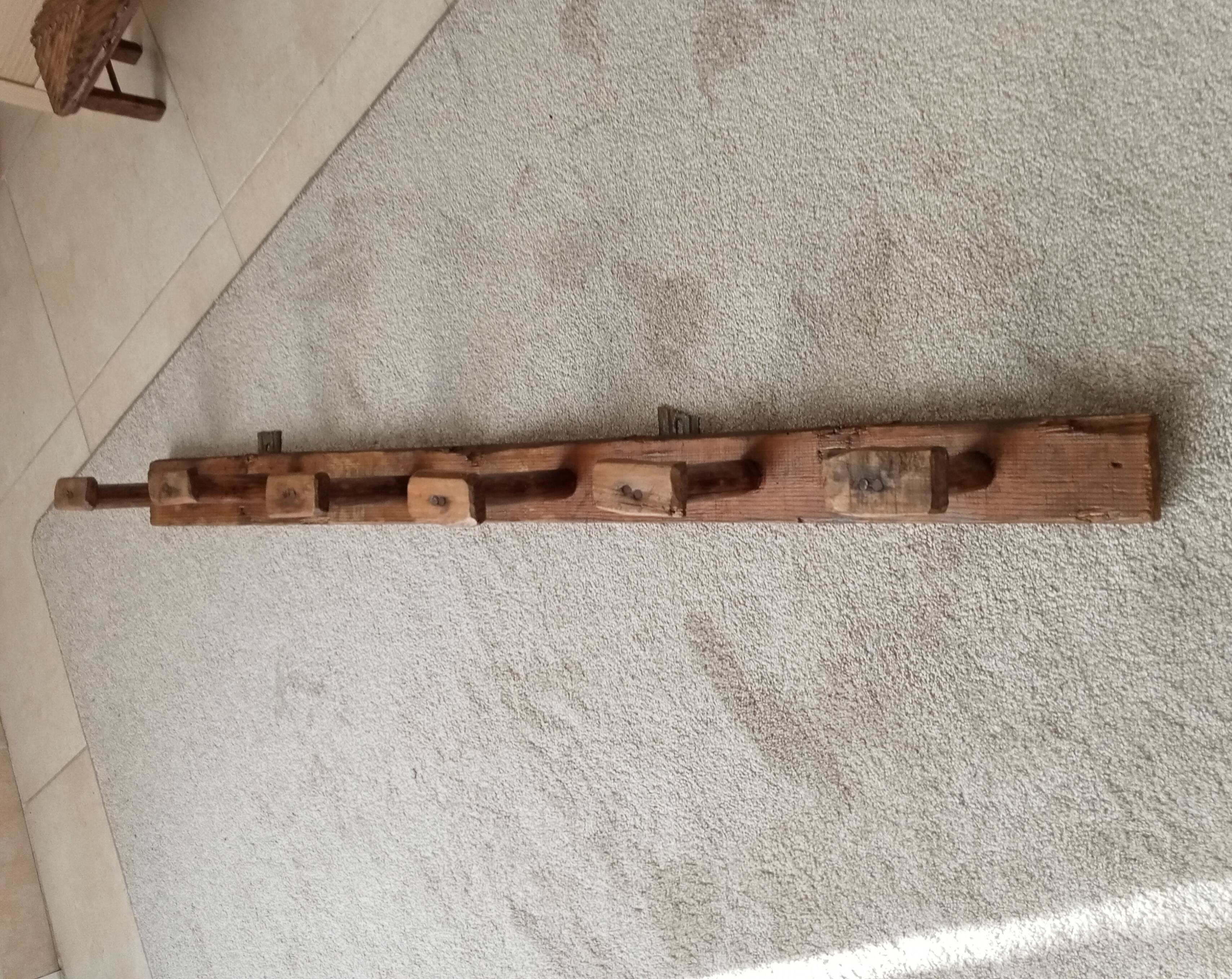 Old wall-mounted coat rack from a stable, folk art.