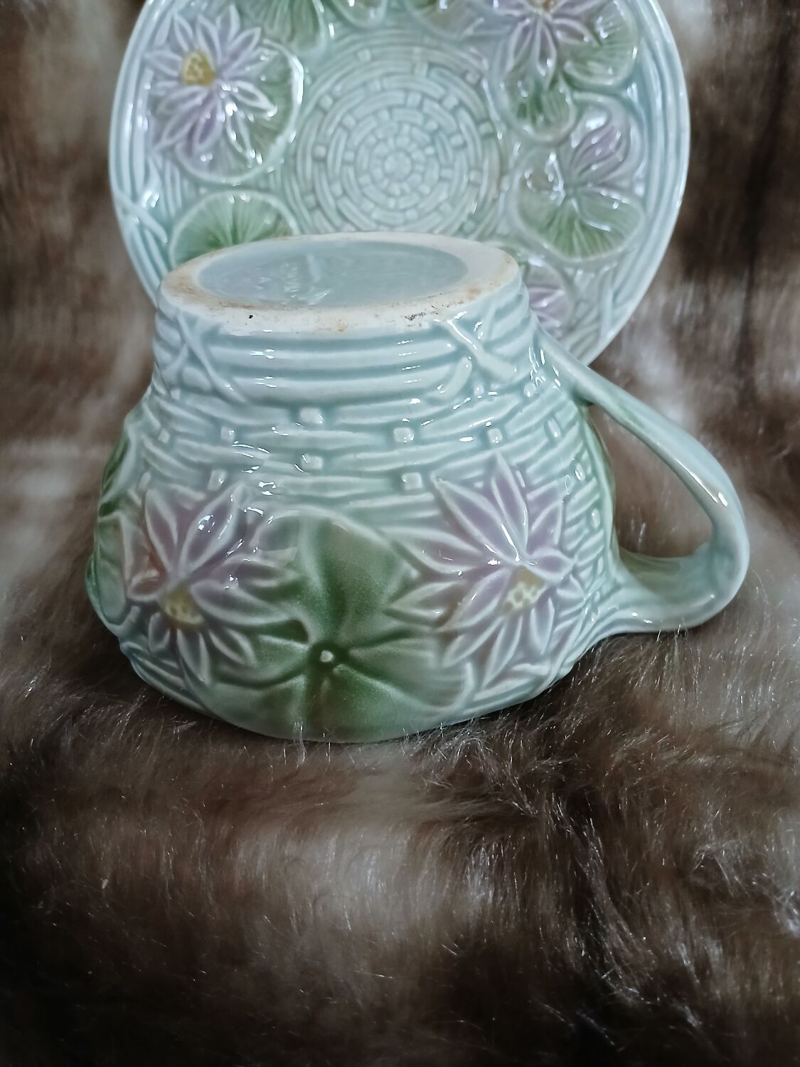 Antique cup and saucer in majolica.