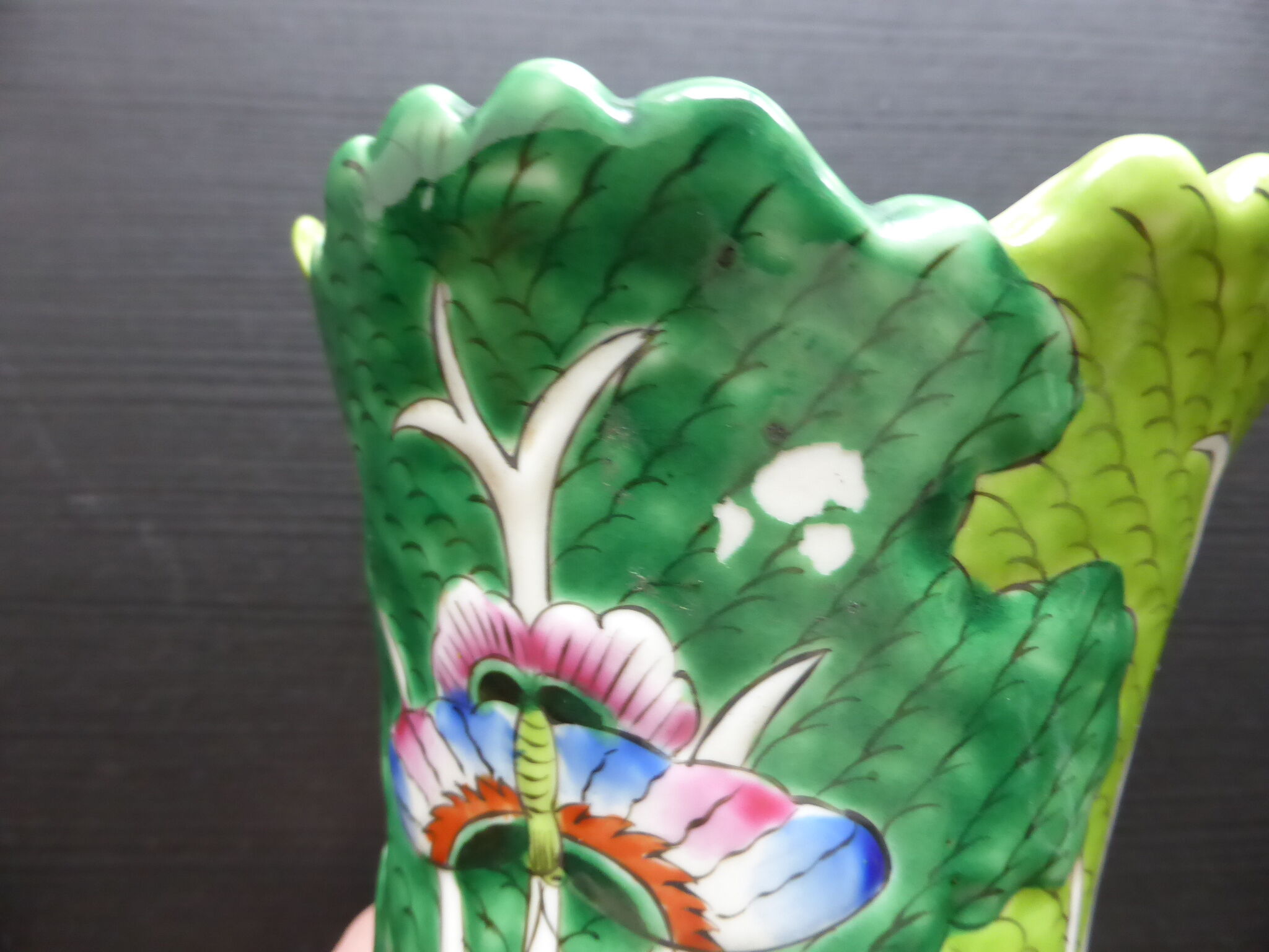 Ancient Asian ceramic vase green and white background decorated with butterflies